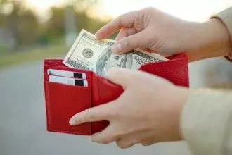 Female holding in hands wallet with dollars money. Banking money, financial management, saving funds